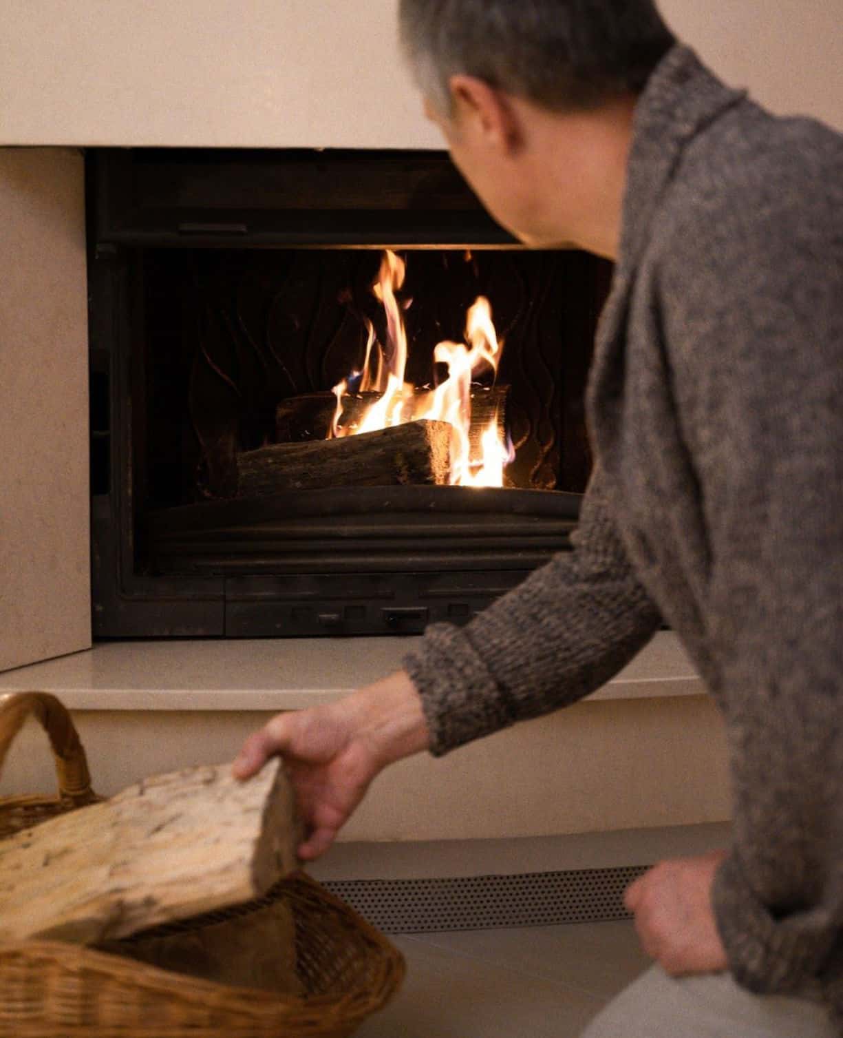 a man standing in front of a fire oven
