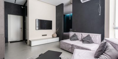 a bedroom with a bed and desk in a room