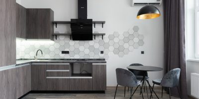 a kitchen with a table and chairs in a room