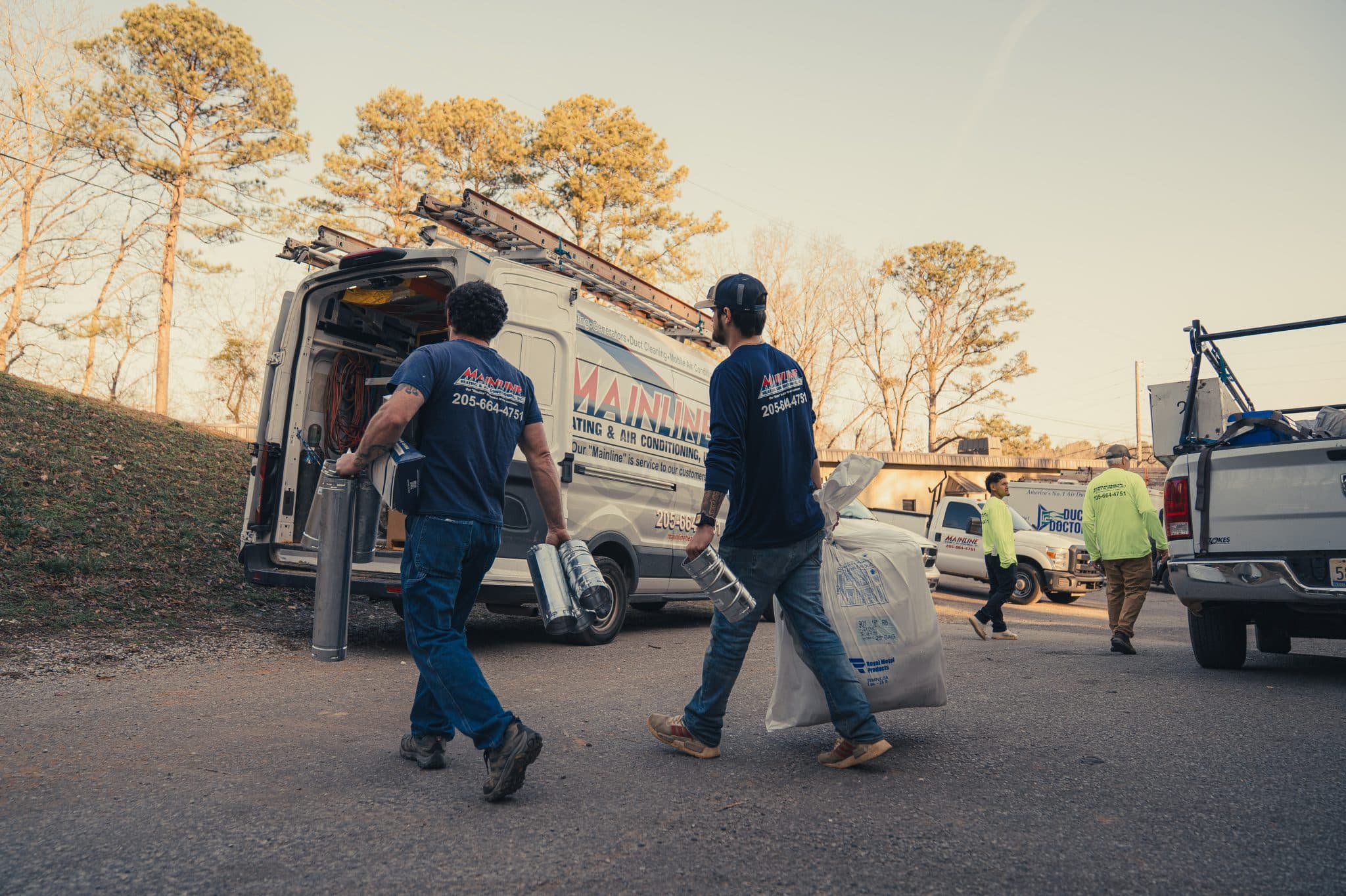 two hvac techs getting the van ready