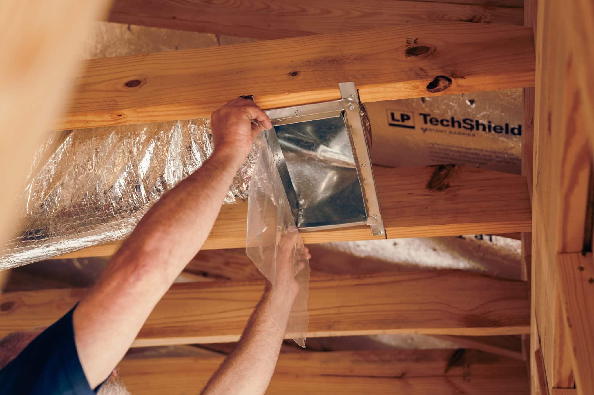 mainline tech working on air duct